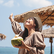 Woman on holiday with coconut drink