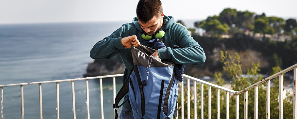 Person looking in their bag for their phone