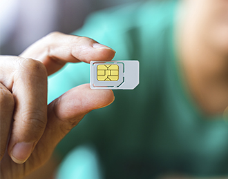 Someone holding a sim card