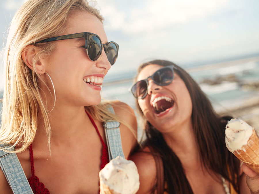 Women eating ice cream on the beach